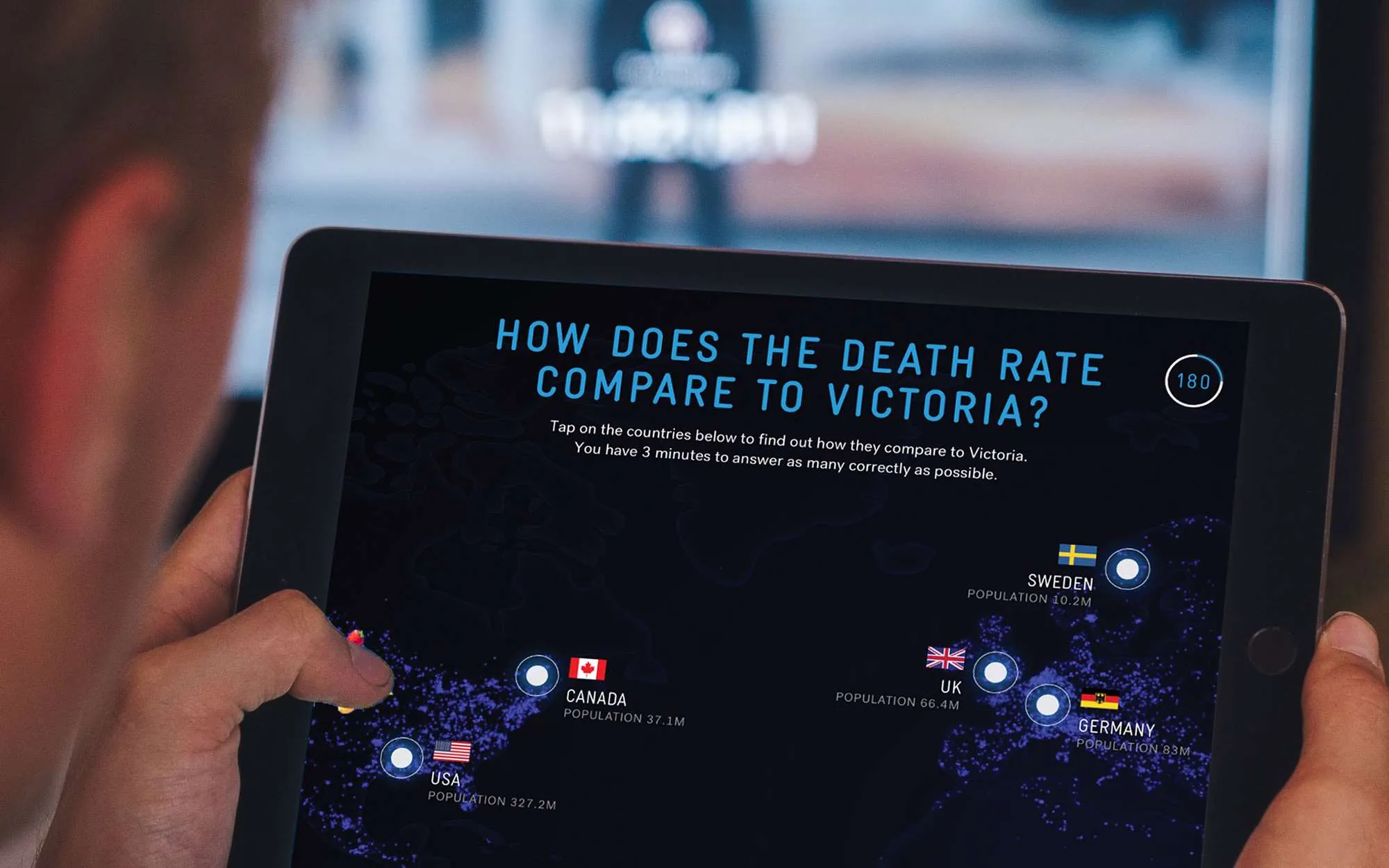 Global Outlook on an iPad, showing an interactive world map and a comparison with Victoria.