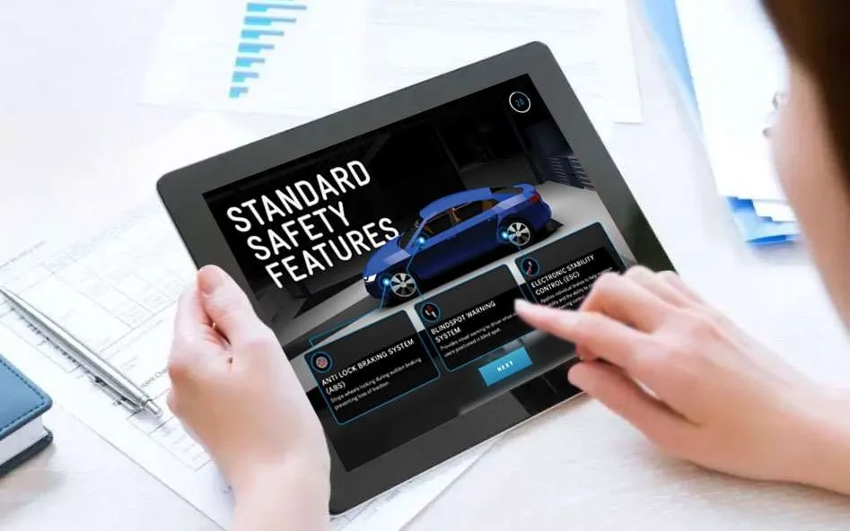 An iPad displays a blue car and the standard safety features screen in Crash Lab
